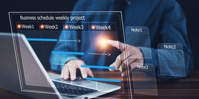 Businessman using computer for project business schedule by weekly, Business plan management concept