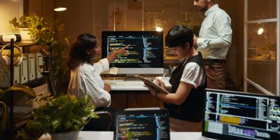 Group of developers working on programming code