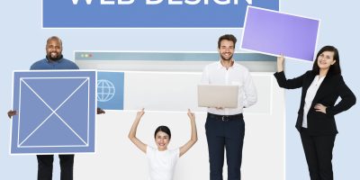 Happy diverse people holding a wed design board